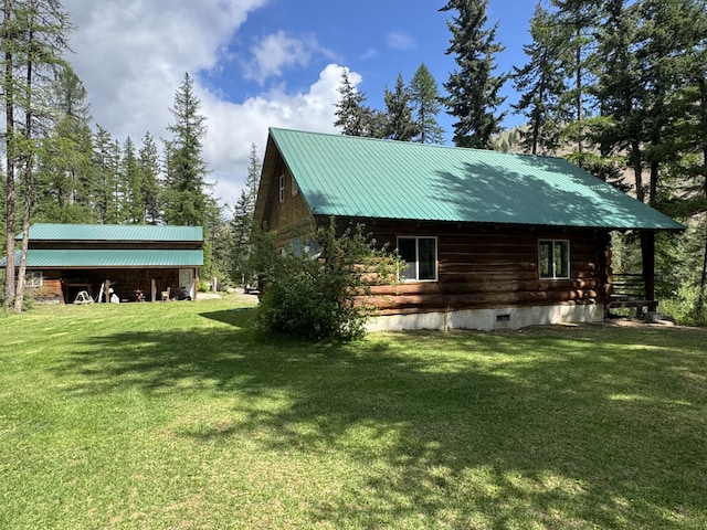 2041 Petty Creek Rd, Alberton, MT 59820 - view of side of home with log siding, a yard, and metal roof