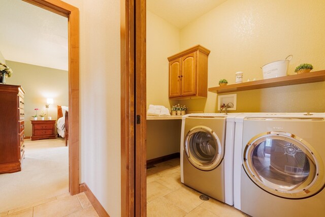 4340 Fox View Loop, Helena, MT 59602 - laundry room with washer and dryer, cabinet space, light tile patterned floors, and light carpet