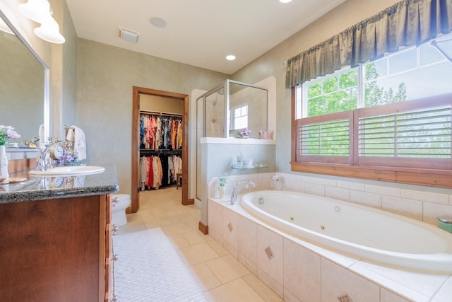 4340 Fox View Loop, Helena, MT 59602 - bathroom with a stall shower, tile patterned flooring, a whirlpool tub, a spacious closet, and vanity