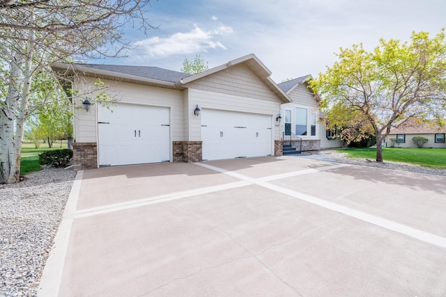 4340 Fox View Loop, Helena, MT 59602 - view of front of property with brick siding, driveway, a garage, and a shingled roof