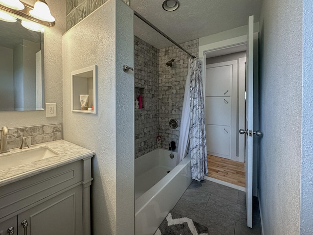 604 27th Ave NE, Great Falls, MT 59404 - full bathroom with a textured wall, tile patterned floors, vanity, shower / bath combo, and a textured ceiling
