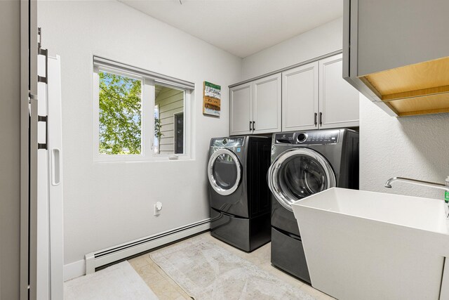 207 Cyprus Dr, Butte, MT 59701 - washroom featuring a baseboard heating unit, cabinet space, and separate washer and dryer