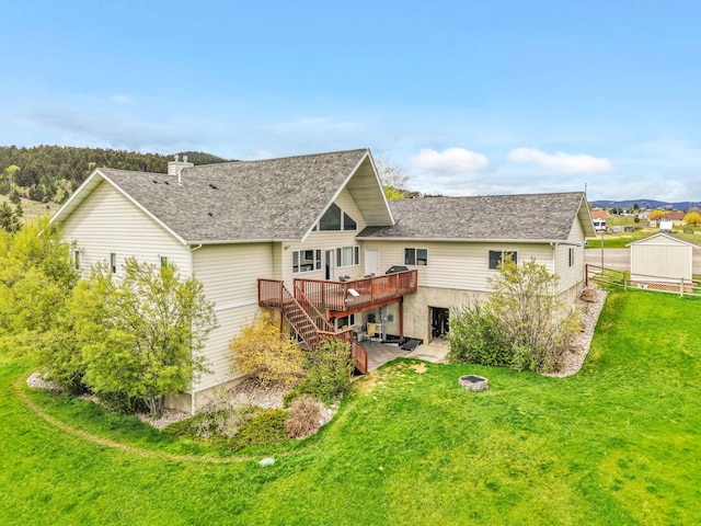 207 Cyprus Dr, Butte, MT 59701 - back of property with a wooden deck, stairway, a lawn, an outdoor fire pit, and a patio