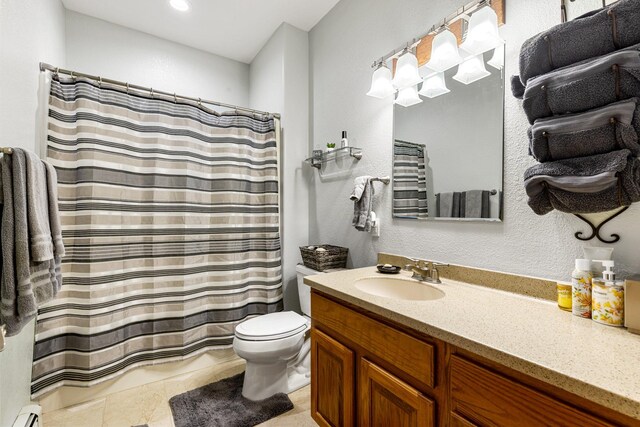 207 Cyprus Dr, Butte, MT 59701 - full bath featuring a baseboard radiator, toilet, vanity, and tile patterned floors