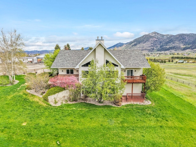 207 Cyprus Dr, Butte, MT 59701 - back of house with a deck with mountain view, a chimney, and a shingled roof