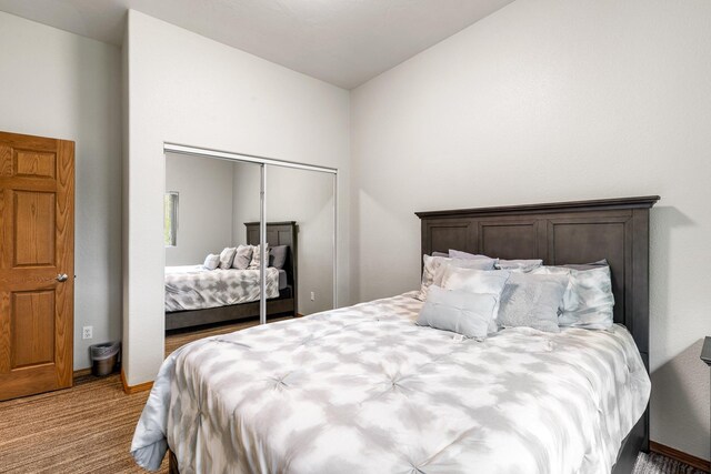 207 Cyprus Dr, Butte, MT 59701 - carpeted bedroom with vaulted ceiling, a closet, and baseboards