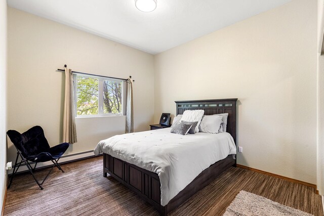 207 Cyprus Dr, Butte, MT 59701 - bedroom with baseboard heating, wood finished floors, and baseboards