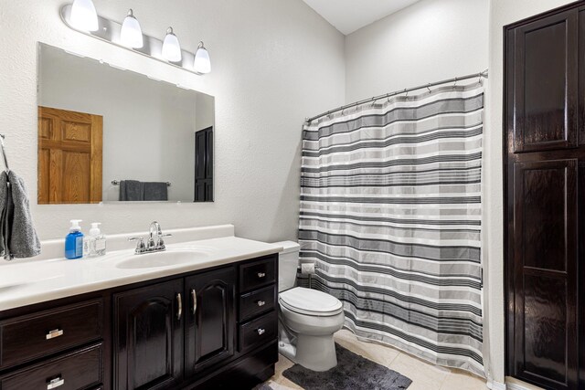 207 Cyprus Dr, Butte, MT 59701 - bathroom with toilet, vanity, and tile patterned flooring