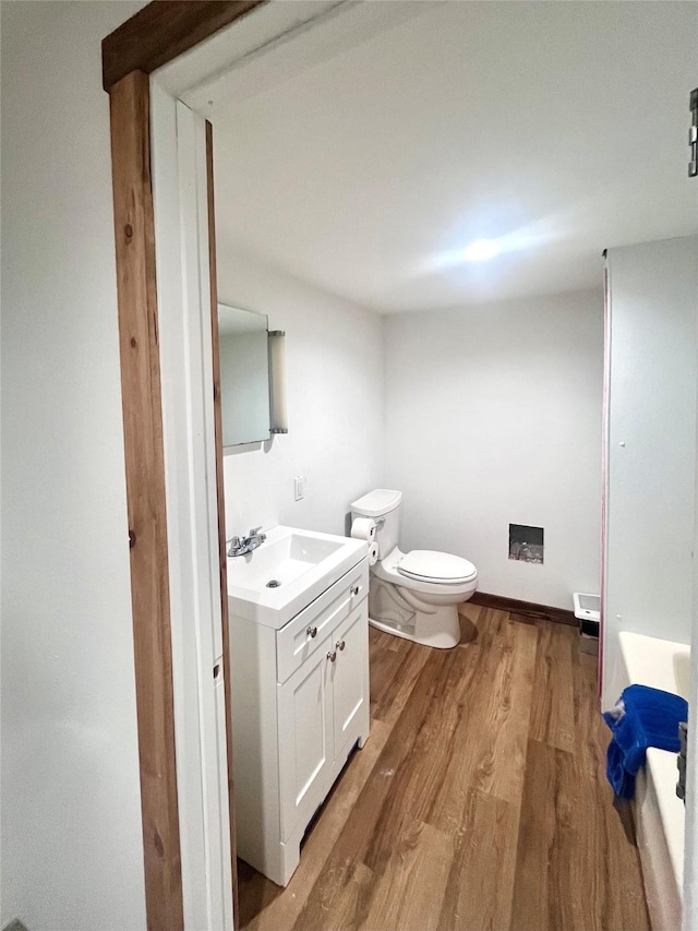 1807 1st St E, Polson, MT 59860 - bathroom featuring wood finished floors, vanity, and toilet
