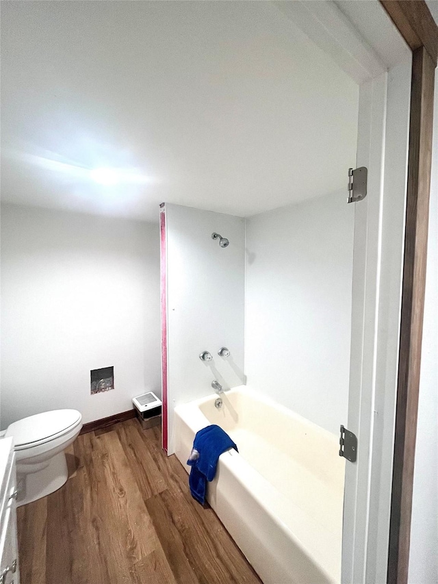 1807 1st St E, Polson, MT 59860 - bathroom featuring wood finished floors, toilet, and shower / washtub combination