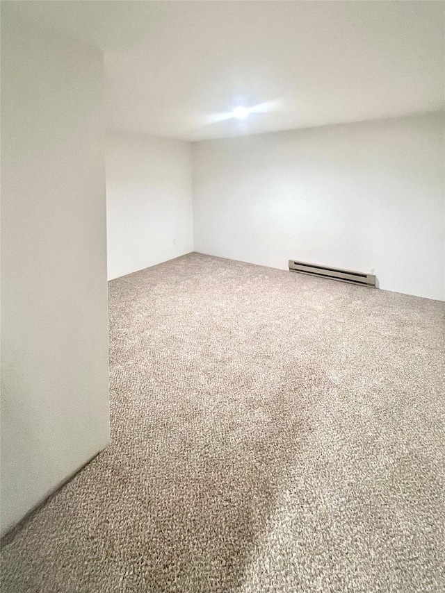 1807 1st St E, Polson, MT 59860 - carpeted empty room featuring a baseboard heating unit