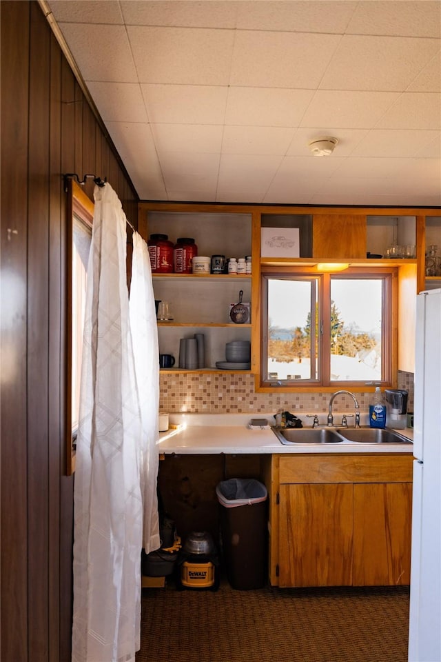 1807 1st St E, Polson, MT 59860 - kitchen with freestanding refrigerator, a sink, tasteful backsplash, and light countertops
