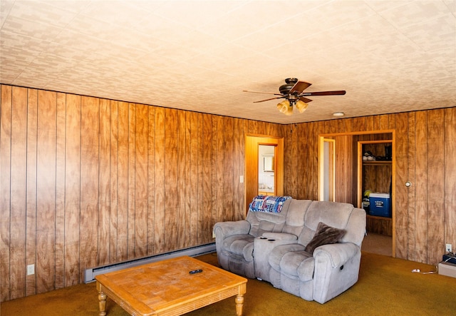 1807 1st St E, Polson, MT 59860 - carpeted living room featuring wood walls, a baseboard radiator, and ceiling fan