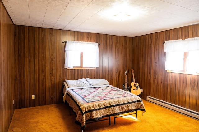 1807 1st St E, Polson, MT 59860 - bedroom with multiple windows, a baseboard heating unit, carpet flooring, and wood walls