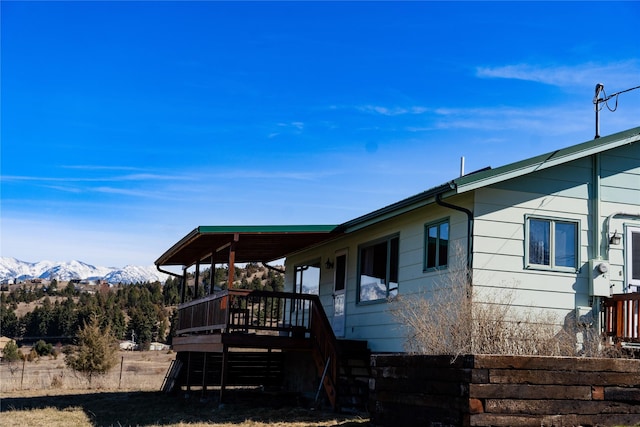 1807 1st St E, Polson, MT 59860 - view of home's exterior featuring a deck with mountain view