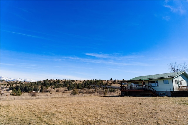 1807 1st St E, Polson, MT 59860 - view of yard featuring a deck with mountain view and stairs