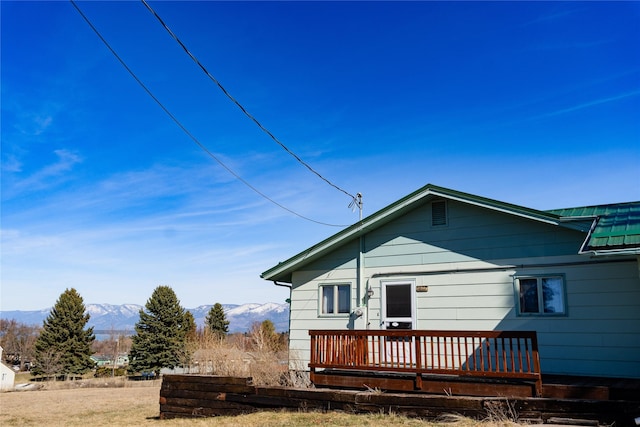 1807 1st St E, Polson, MT 59860 - rear view of house with a deck with mountain view