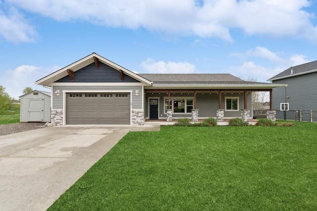 115 Triple Creek Dr, Kalispell, MT 59901 - craftsman-style house featuring stone siding, covered porch, a front yard, and a garage