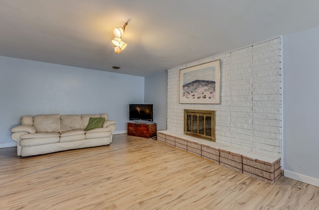 2046 Fairway Dr, Billings, MT 59102 - living room featuring wood finished floors, baseboards, and a brick fireplace