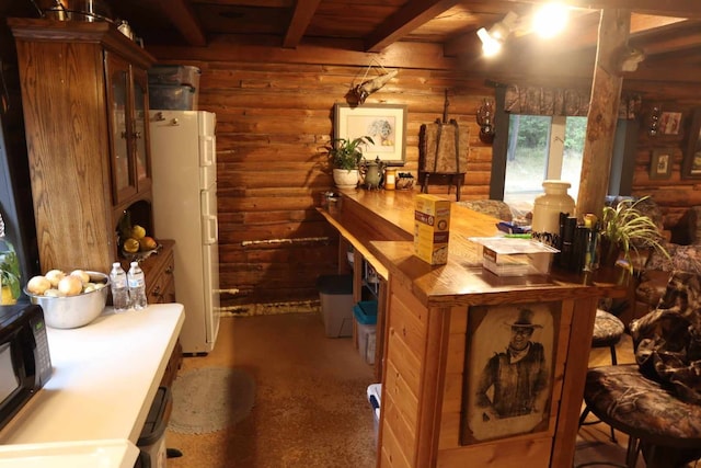 127 Lonely Moose Ln, Alberton, MT 59820 - kitchen with rustic walls, freestanding refrigerator, black microwave, glass insert cabinets, and wooden ceiling with exposed beams