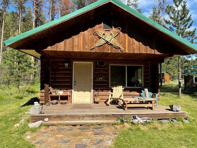 127 Lonely Moose Ln, Alberton, MT 59820 - back of house featuring log siding, a deck, and an outdoor structure