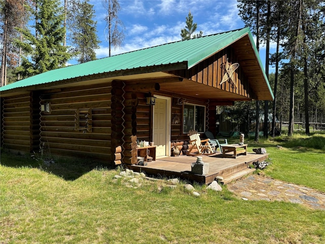 127 Lonely Moose Ln, Alberton, MT 59820 - rear view of house with a deck, a lawn, log siding, and metal roof