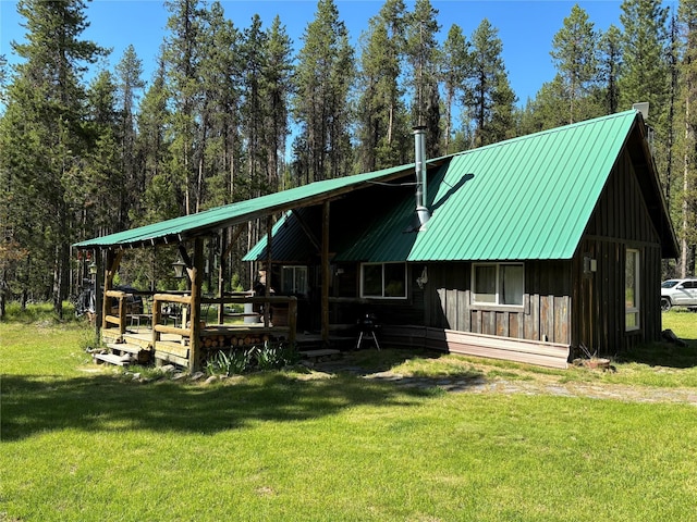 127 Lonely Moose Ln, Alberton, MT 59820 - rear view of house with board and batten siding, a yard, and metal roof
