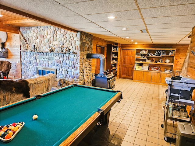215 Somerset Dr, Kalispell, MT 59901 - playroom featuring wooden walls, tile patterned floors, a wood stove, billiards table, and built in shelves