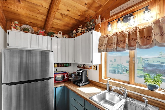 5 Lake Flat Ln, Great Falls, MT 59404 - kitchen featuring freestanding refrigerator, a sink, wooden ceiling, white cabinetry, and butcher block countertops