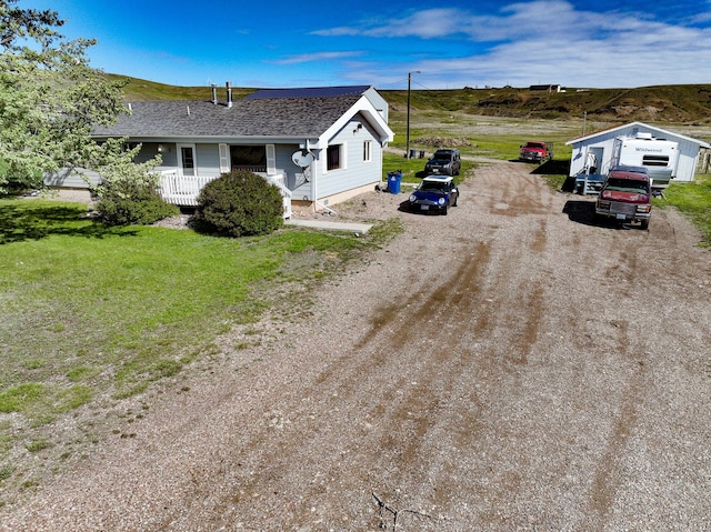 5 Lake Flat Ln, Great Falls, MT 59404 - ranch-style house featuring a porch, a shingled roof, and dirt driveway