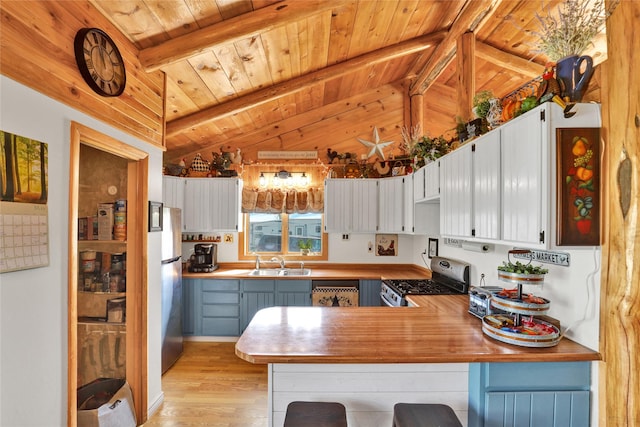 5 Lake Flat Ln, Great Falls, MT 59404 - kitchen featuring appliances with stainless steel finishes, wood ceiling, a peninsula, light wood-style floors, and a breakfast bar