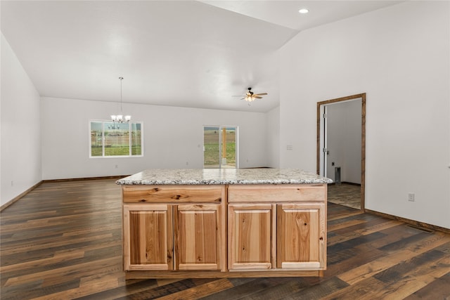 4452 Ludwig Ln, Stevensville, MT 59870 - kitchen featuring dark wood-type flooring, baseboards, a chandelier, light stone counters, and high vaulted ceiling