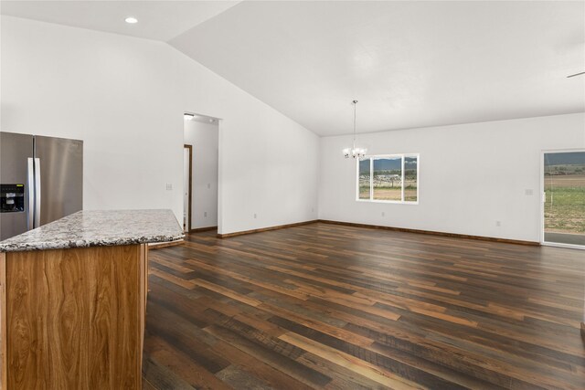 4452 Ludwig Ln, Stevensville, MT 59870 - unfurnished living room with vaulted ceiling, dark wood finished floors, a chandelier, baseboards, and recessed lighting