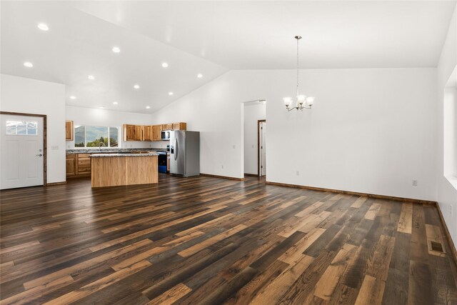 4452 Ludwig Ln, Stevensville, MT 59870 - kitchen with stainless steel appliances, open floor plan, brown cabinets, a chandelier, and a kitchen island