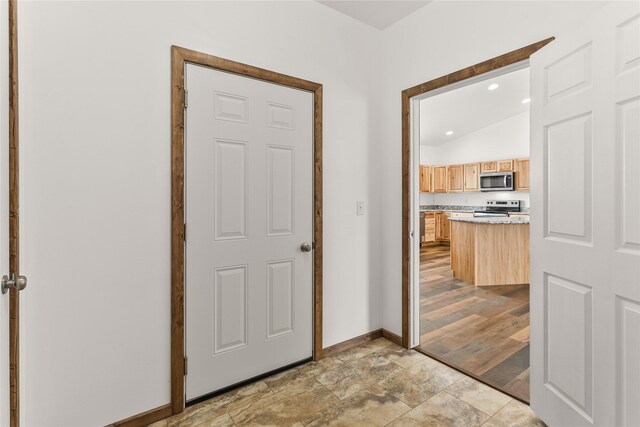 4452 Ludwig Ln, Stevensville, MT 59870 - hall featuring baseboards, vaulted ceiling, recessed lighting, and light stone finish flooring