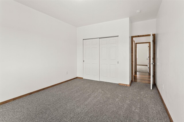 4452 Ludwig Ln, Stevensville, MT 59870 - unfurnished bedroom featuring carpet floors, a closet, and baseboards