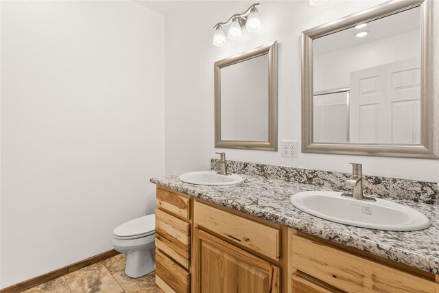 4452 Ludwig Ln, Stevensville, MT 59870 - full bathroom with toilet, double vanity, and baseboards
