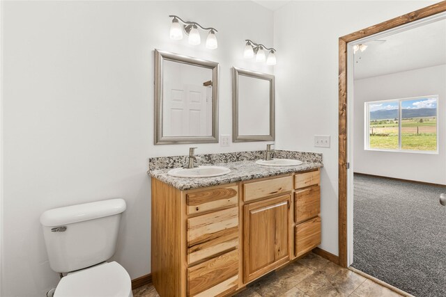 4452 Ludwig Ln, Stevensville, MT 59870 - full bath with baseboards, toilet, and double vanity