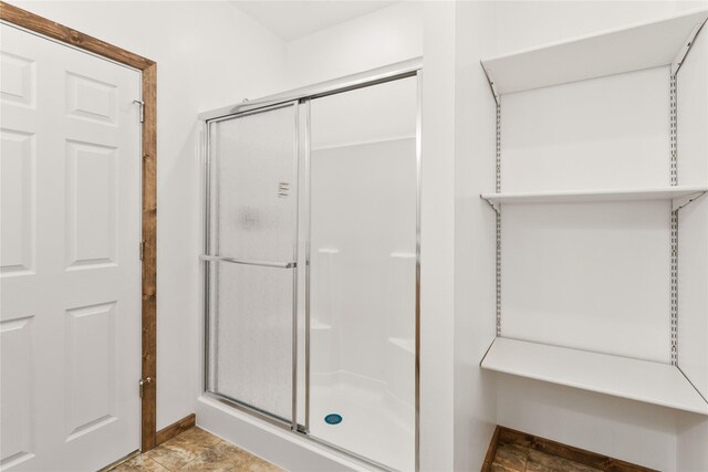 4452 Ludwig Ln, Stevensville, MT 59870 - bathroom featuring a stall shower and stone finish flooring