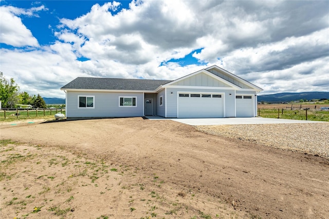 4452 Ludwig Ln, Stevensville, MT 59870 - ranch-style home with concrete driveway, an attached garage, and board and batten siding