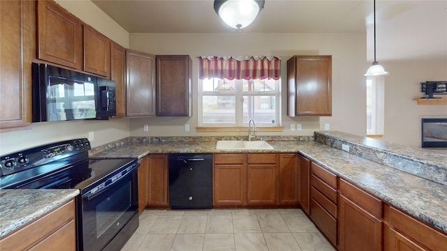 4100 Mullan Rd Unit 712, Missoula, MT 59808 - kitchen featuring black appliances, a sink, brown cabinetry, and hanging light fixtures