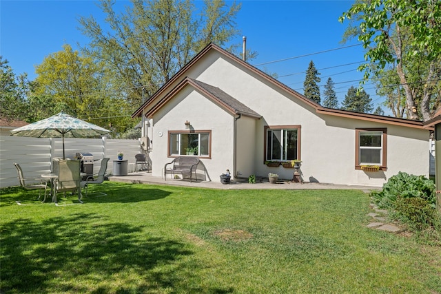 776 1st Ave, Kalispell, MT 59901 - back of house with stucco siding and a patio