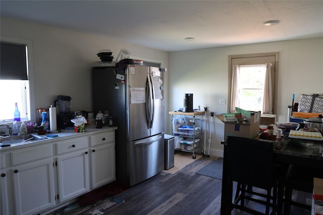 507 2nd St, Valier, MT 59486 - kitchen with a sink, freestanding refrigerator, dark wood-style flooring, white cabinets, and light countertops