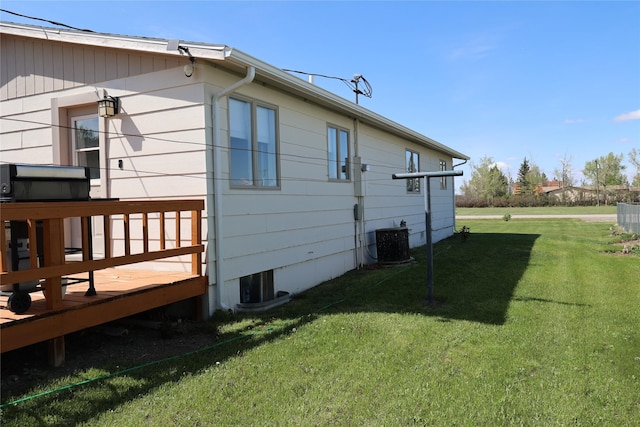 507 2nd St, Valier, MT 59486 - back of property featuring a lawn, a deck, and cooling unit