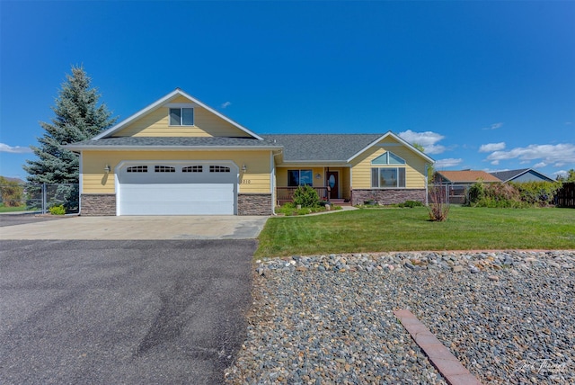 view of front of property featuring stone siding, driveway, and an attached garage