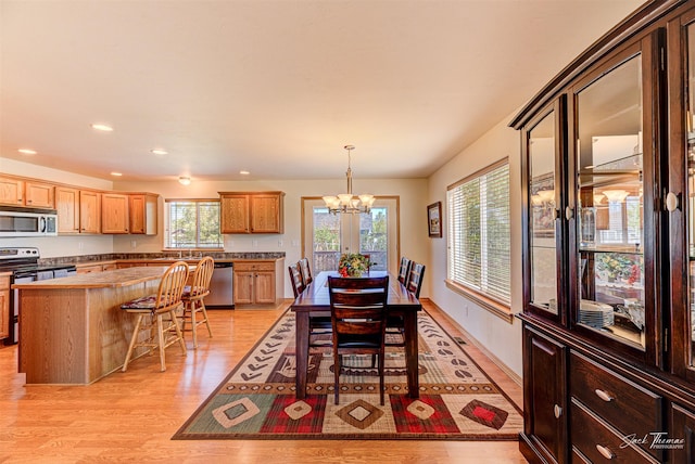dining room featuring light wood finished floors, a chandelier, and recessed lighting