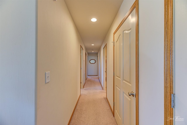corridor with recessed lighting and light carpet