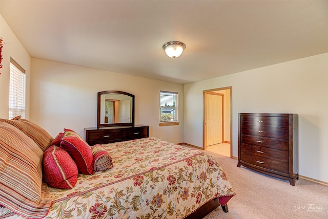 bedroom featuring light colored carpet and baseboards