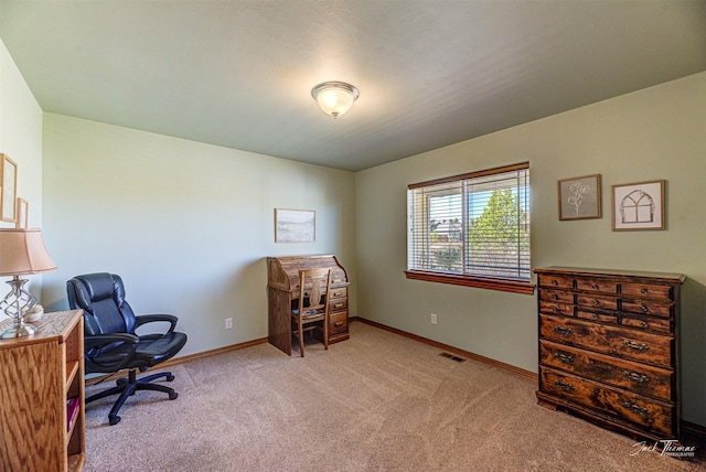 carpeted home office featuring baseboards