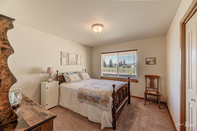 bedroom featuring light carpet and baseboards